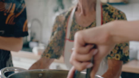 family cooking fresh homemade pasta in pot of boiling water