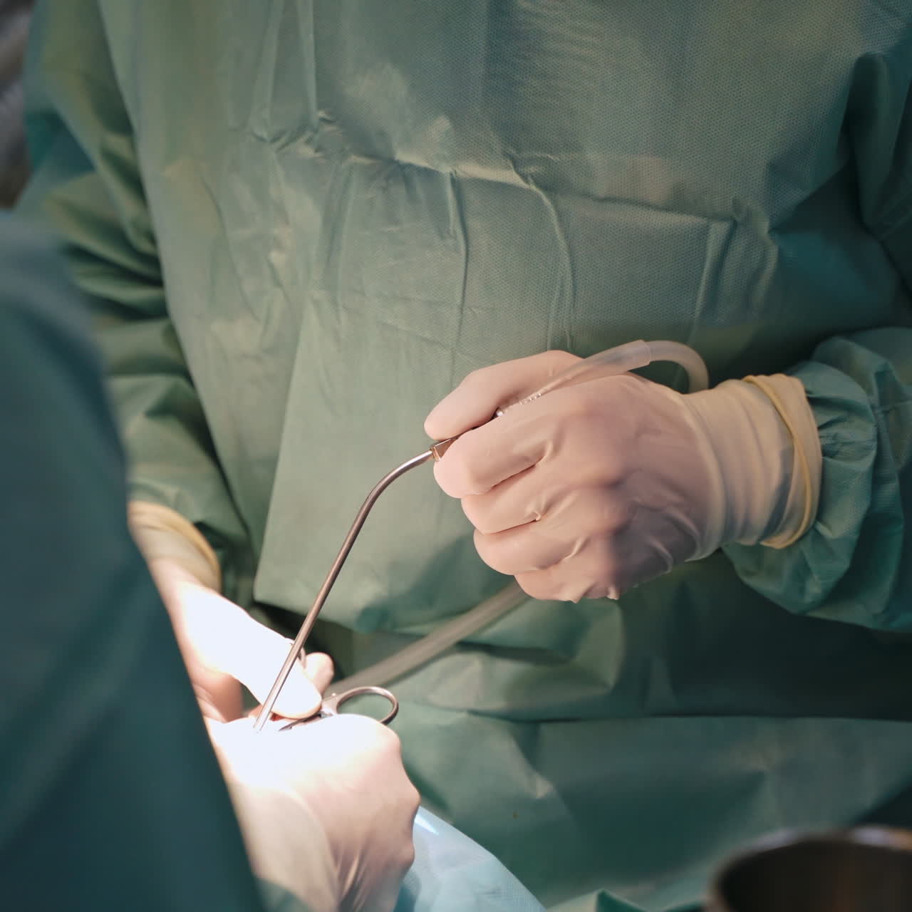 Close-up doctor's hands during operation. Surgeons use medical instruments when making surgery. Specialists in white sterile gloves during operating process.