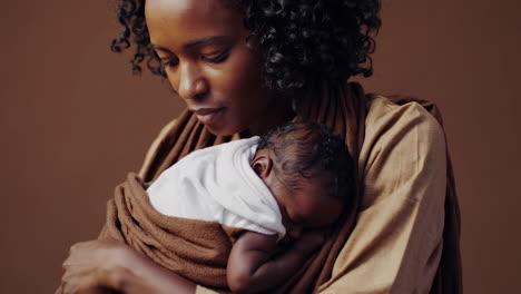 a woman tenderly holding her newborn baby