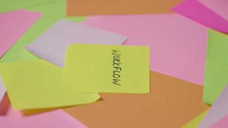 business concept of revolving sticky notes with workflow written on top note 1