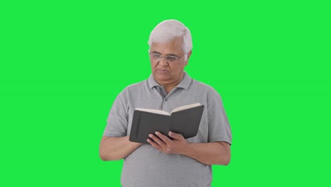 indian old man reading a book green screen
