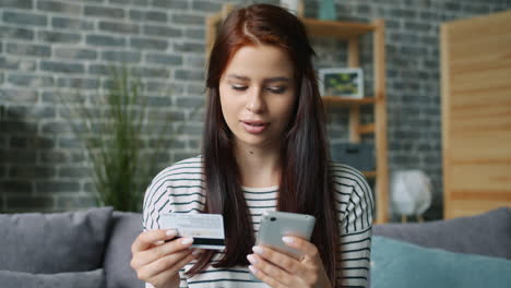 woman using smartphone to make a payment with credit card