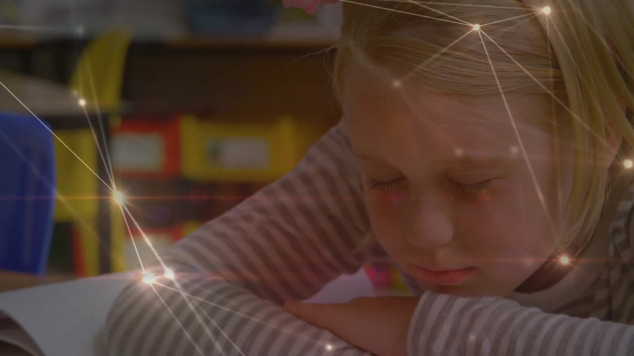 Child reading book in classroom, initiating translucent network overlay mapping comprehension