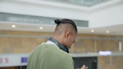 Luggage,-phone-and-a-black-man-on-an-escalator