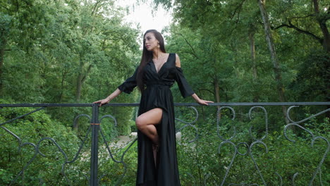 East-European-girl-wearing-a-black-dress-and-high-heels,-looking-side-to-side-and-then-to-the-camera