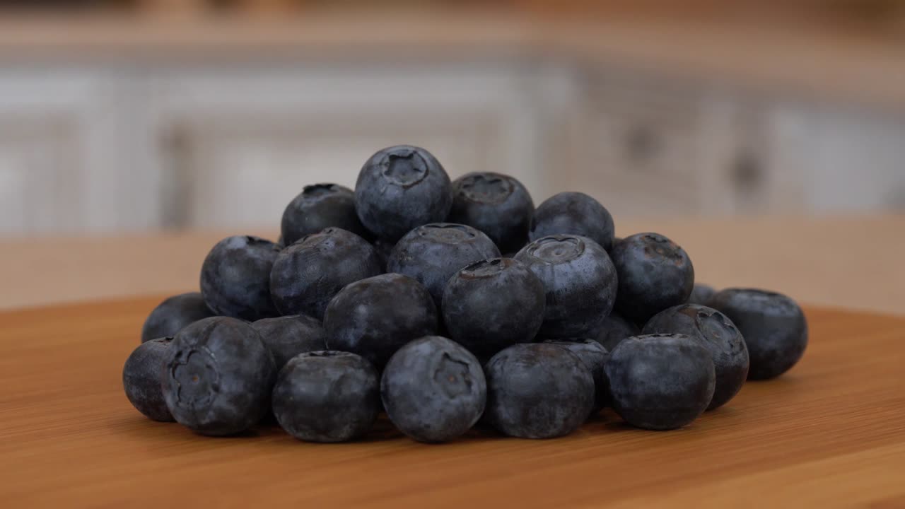 여러 가지 블루베리 베리의 클로즈업. 백색 주방을 배경으로 회전하는 카메라. dolly-shot.