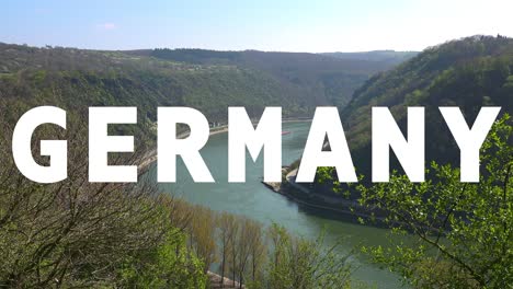 Aerial-Drone-Shot-Of-River-With-Cargo-Boats-With-Animated-Graphic-Spelling-Out-Germany