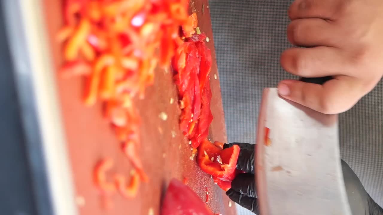 Chopping red peppers for cooking