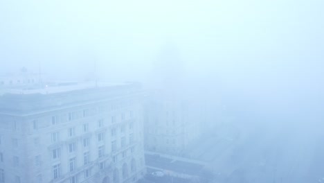 thick dense ghostly fog cover across liverpool city aerial view of surreal downtown waterfront forward descent