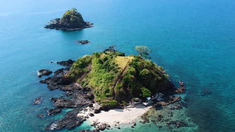 Aerial-of-small-island-off-the-coast-of-Nacpan-beach,-El-Nido-,-Palawan,-Philippines