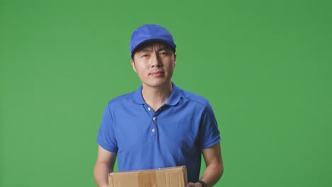 delivery person holding package on green screen