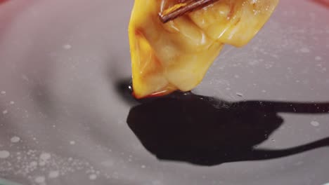 dipping dumplings in sauce