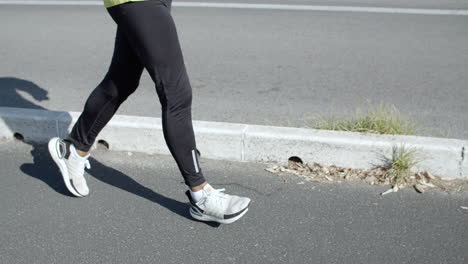 active senior jogger with headphones running outside