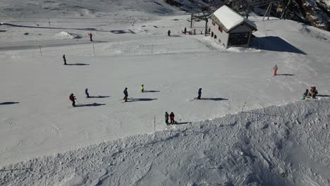 aerial view of skiers going downhill in a swiss alps ski station, saas fee