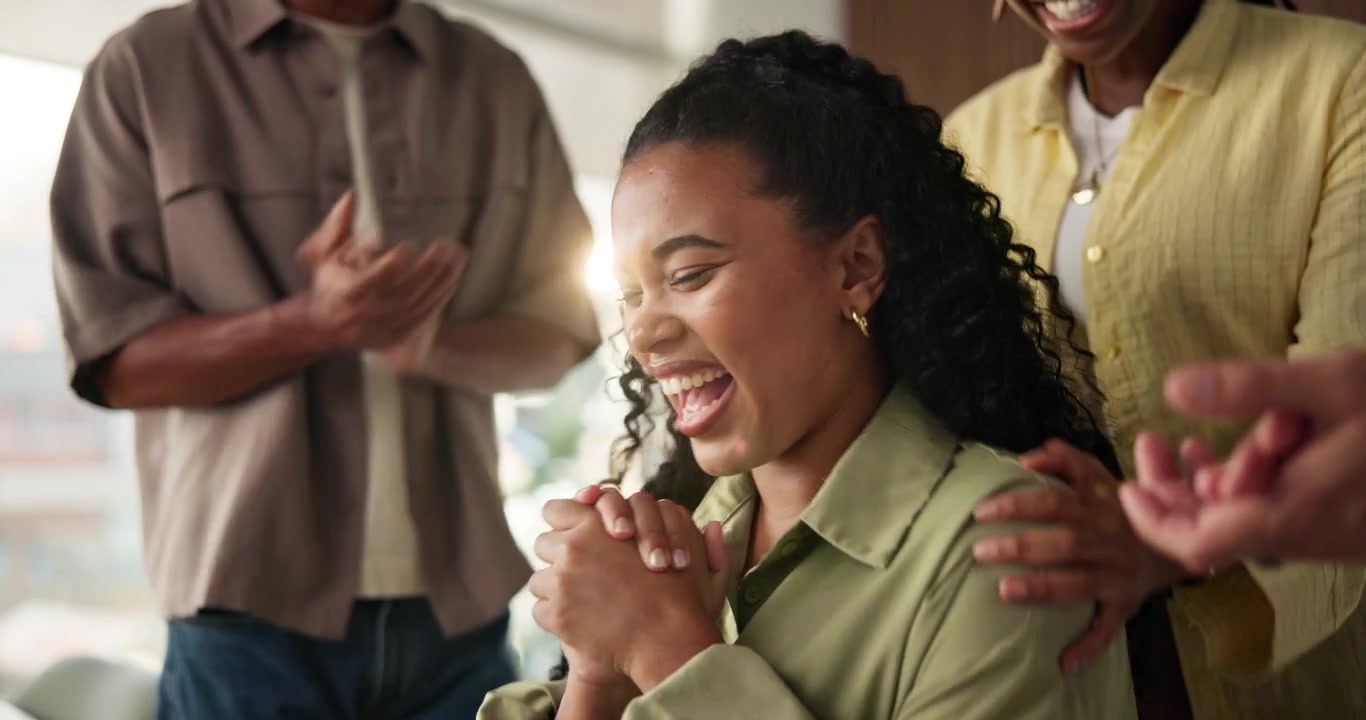 Excited Young Woman Celebrating Success with Colleagues