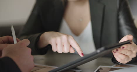 extreme close up of business woman's hands using tablet computer 1