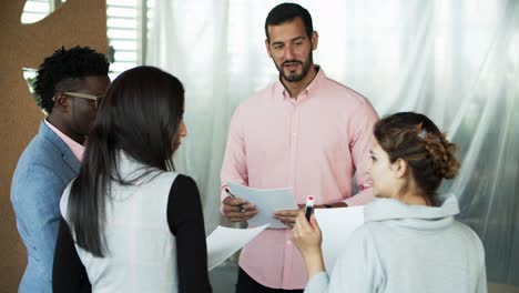 Cheerful-young-people-standing-in-circle-and-talking