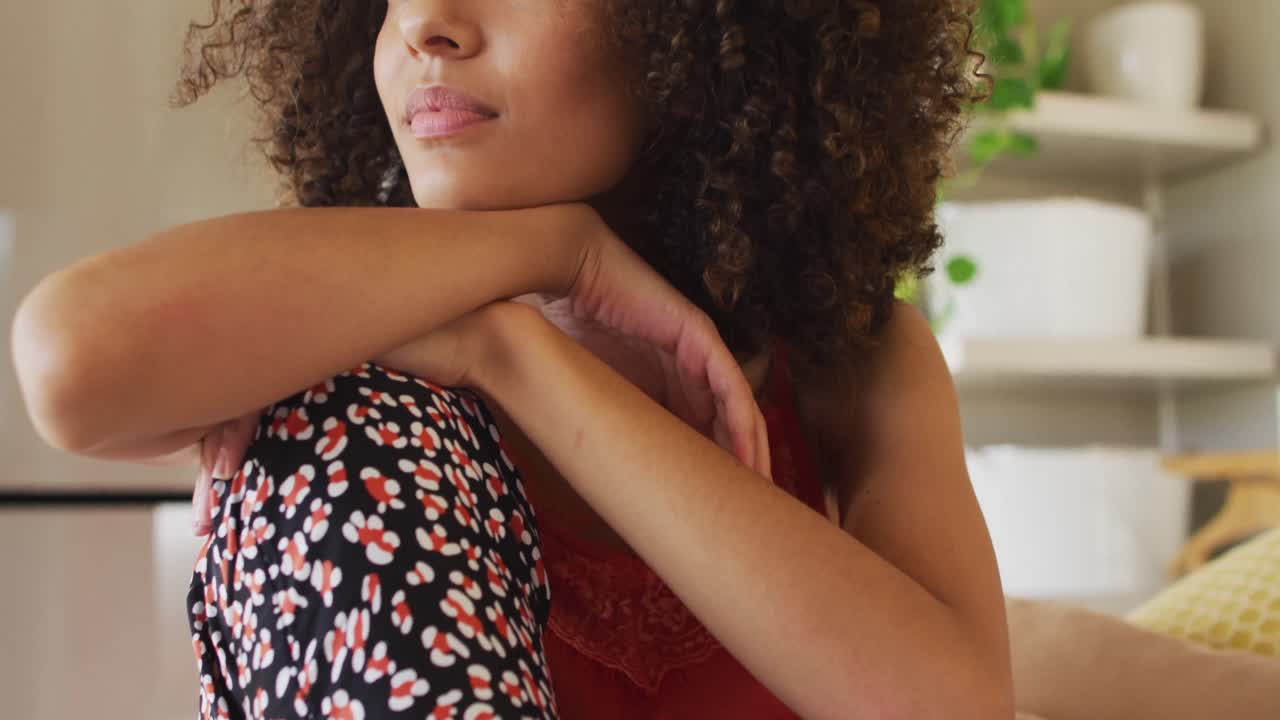 Portrait of african american woman sitting on bed smiling