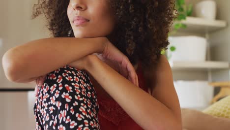 portrait of african american woman sitting on bed smiling