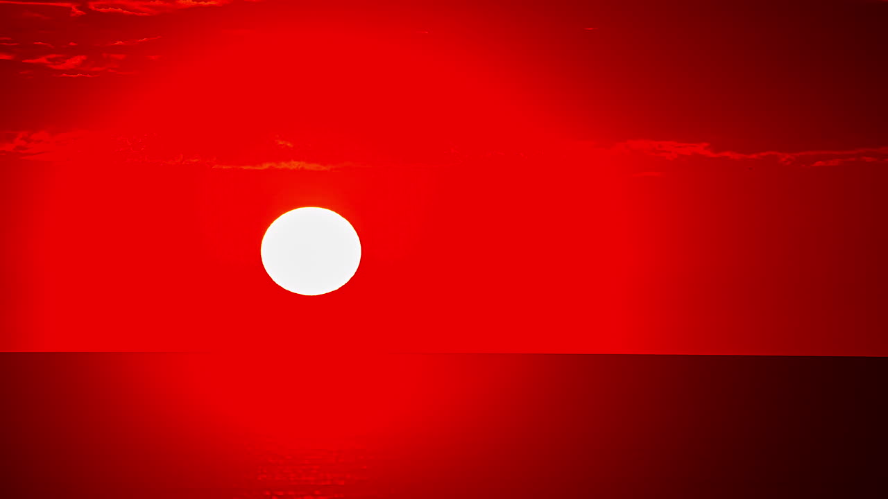 Dark Red Sky With Bright Sun Rising Above Sea On The Horizon.- Wide Shot