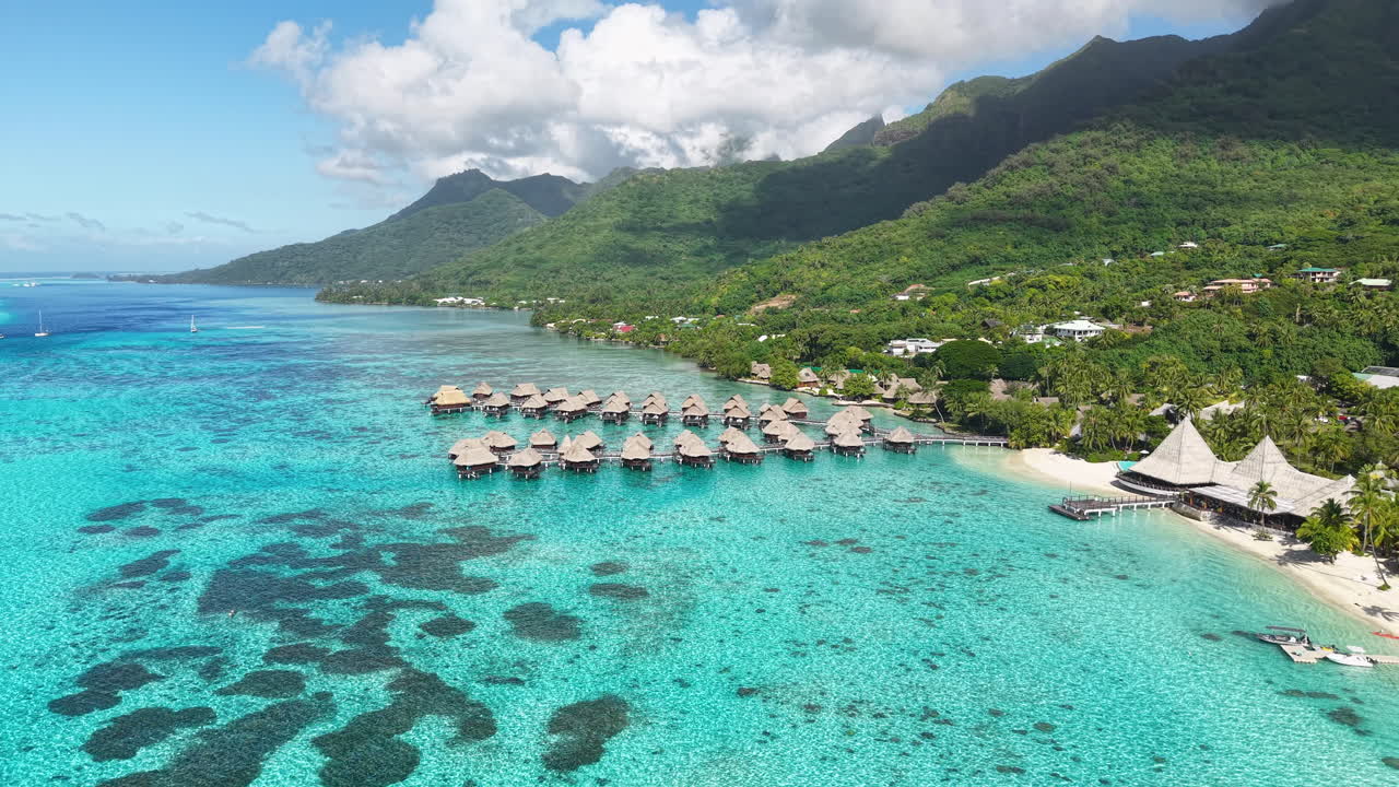 Moorea Island, French Polynesia. Drone Shot of Turquoise Lagoon and Luxury Resort With Bungalows Over Water