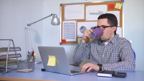 man working on laptop in office