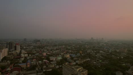 aerial establishing pink smog skyline at dusk bangkok, thailand