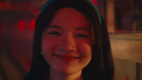 smiling young woman in a cafe at night