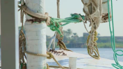 Sailboat-deck-with-mast-and-rigging-ropes-sailing-near-coast,-close-up