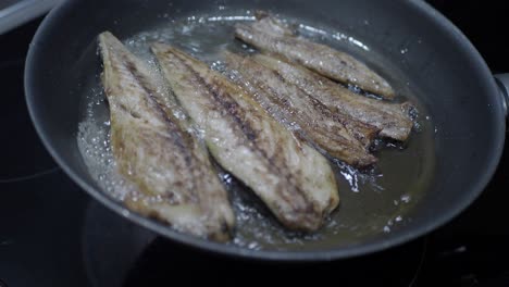 frying fish in a pan