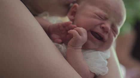 newborn baby sleeping in mums arms