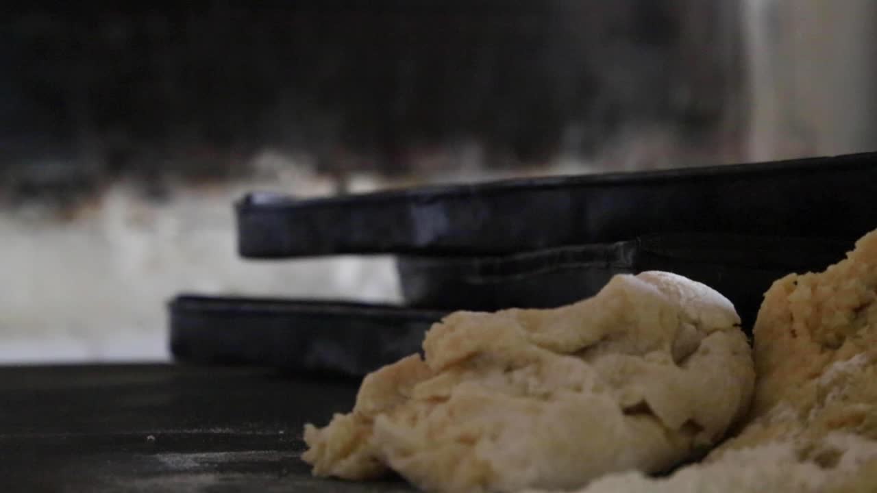 Hands Kneading Dough and Baking Bread in a Rustic Oven
