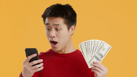 Happy Man Holding Money and Smartphone
