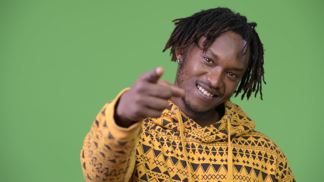 Young handsome African man pointing at camera