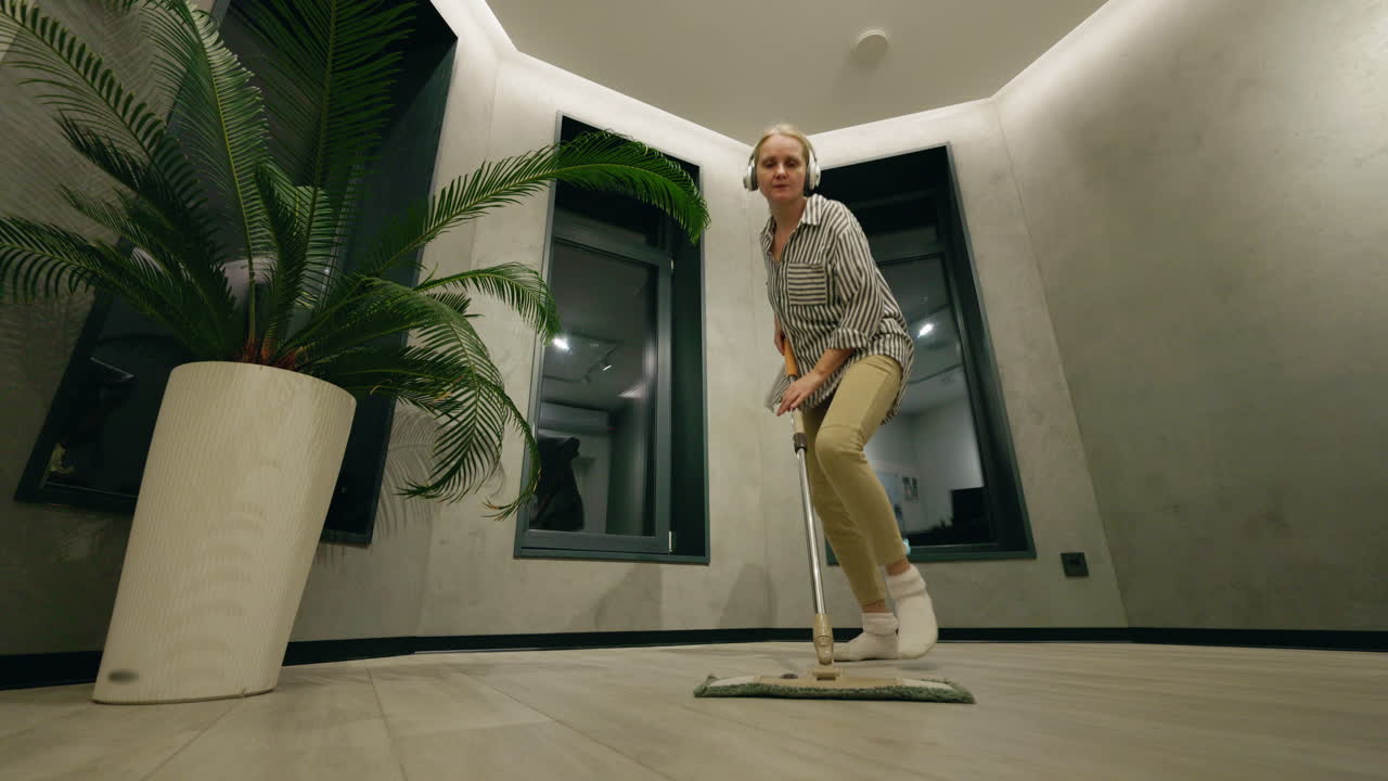 Woman Mopping the Floor in a Modern Home