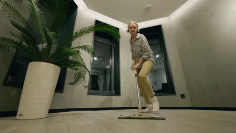 woman mopping the floor in a modern home