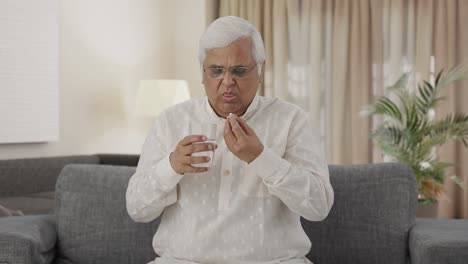 Sick-Indian-old-man-taking-the-medicine