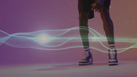 animation of mesh and neon pattern over african american basketball player