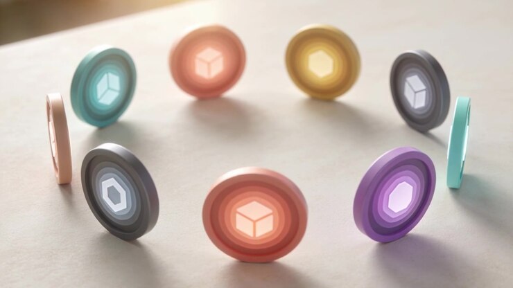 Rocking colorful ringed tokens tilting on pale table, left light causing cube emblems to brighten