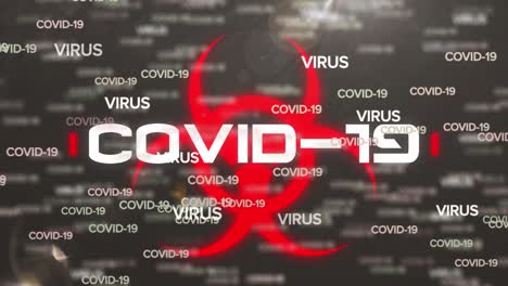 Animation-of-covid-19-text-and-biohazard-symbol-over-grey-background