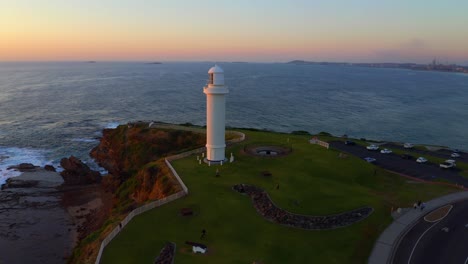 wollongong head lighthouse at sunset in sydney, new south wales, australia - aerial drone shot