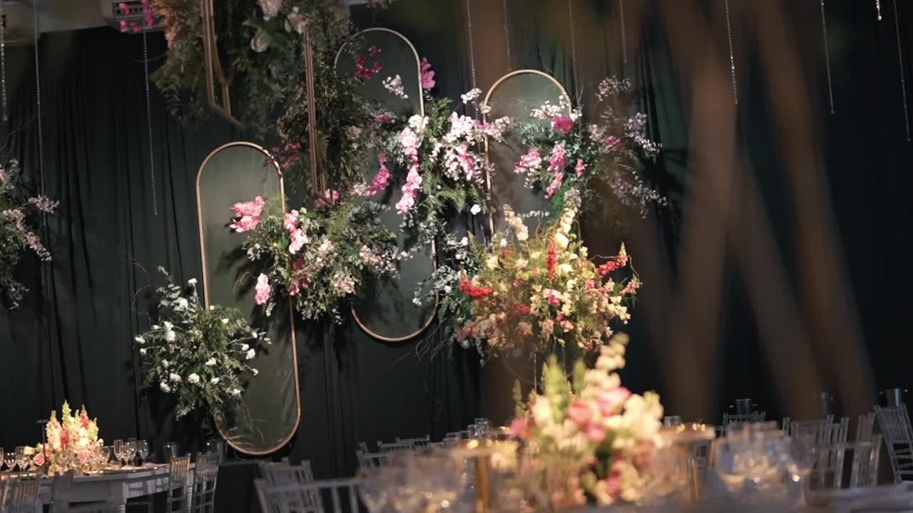 Soft-focused foreground framing elegant floral wedding table decor with warm lighting