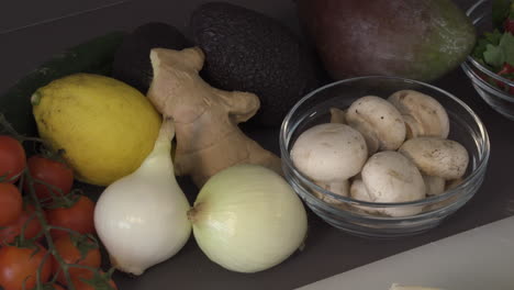 strawberries, button mushrooms, white onions, ginger, lemon, and red tomatoes in the kitchen - closeup shot
