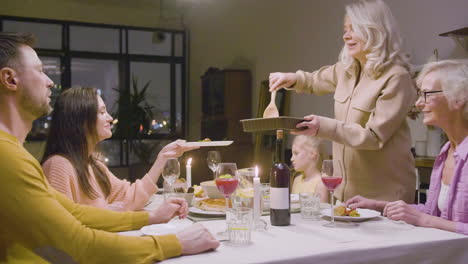 Family-Sitting-At-The-Table-During-Dinner-At-Home-2