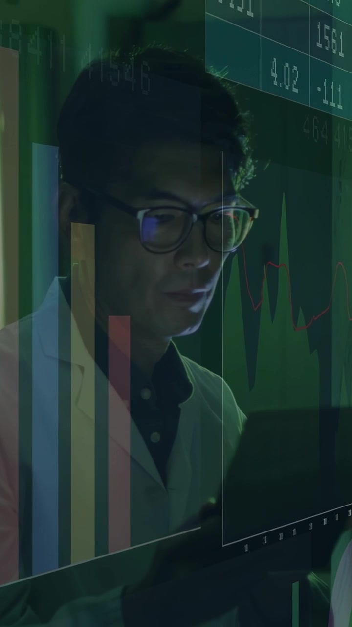 Vertical video: Analyst raising tablet and scanning bar charts and number tickers, analyzing data