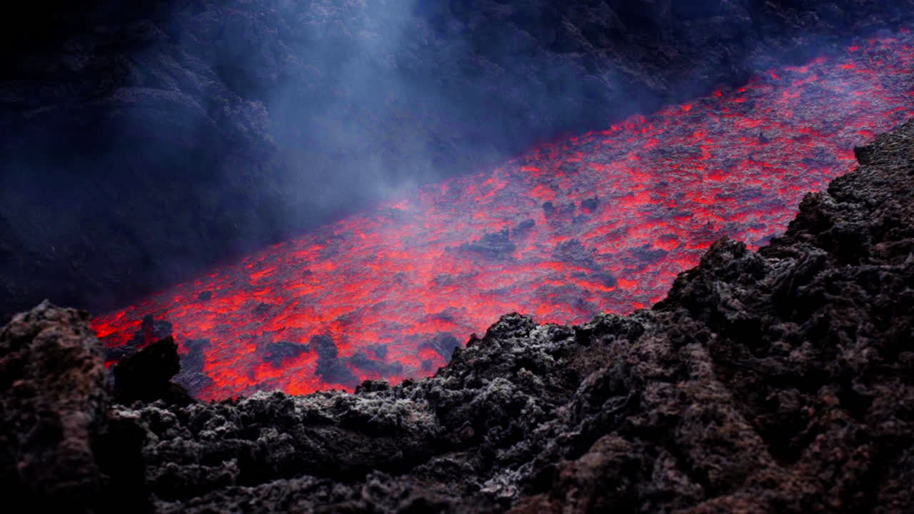 Fiery lava flow on Mount Etna in Sicily, showcasing volcanic activity