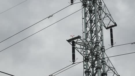 Electricity-Pylon-and-Weather-Vane-in-Strong-Winds