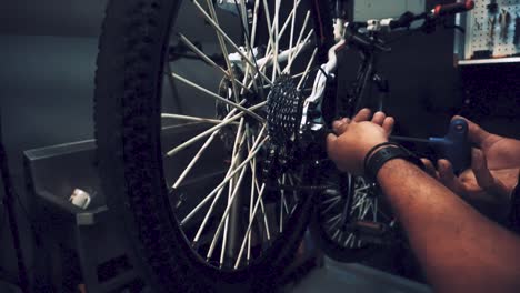 a by-cycle maker is working at his cycle garage