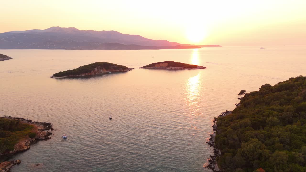 Golden sunset over Ksamil, Albania, with islands and forested coastline, peaceful and scenic