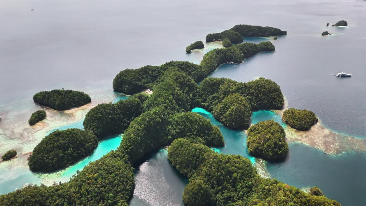 Aerial view of Sohoton Cove in the Siargao Islands, Philippines, revealing lush green limestone islets, turquoise lagoons, coral reefs, and clear ocean waters surrounded by serene natural beauty